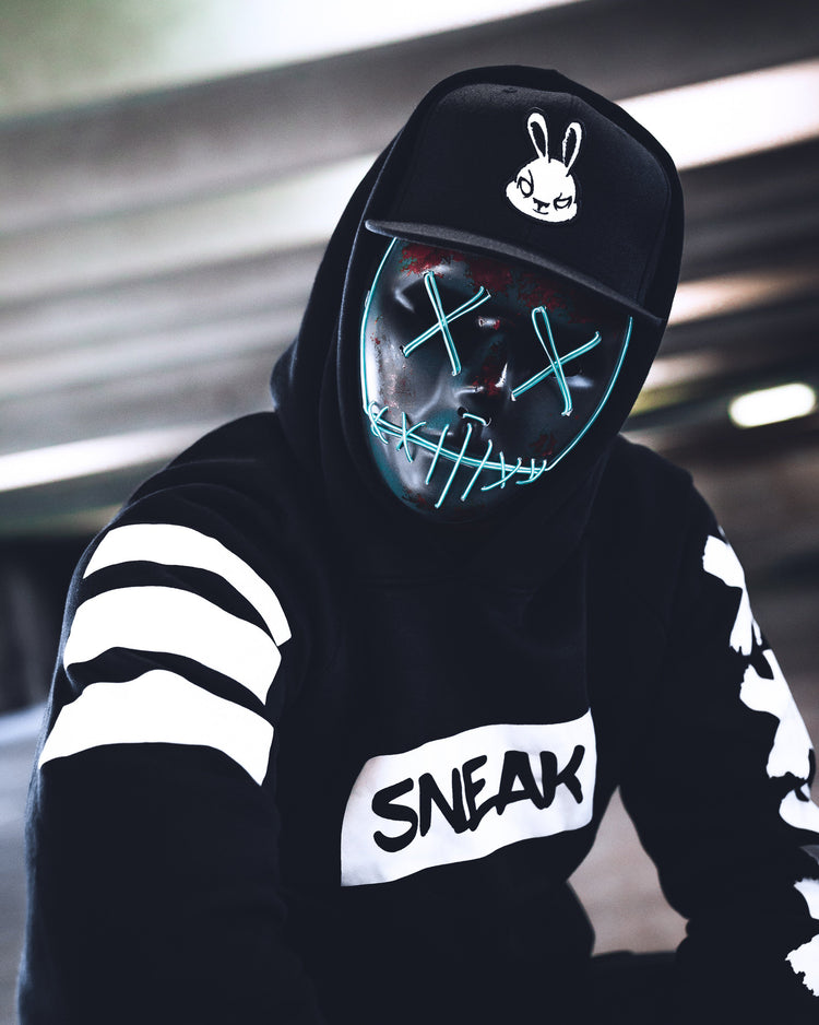 model wearing snapback and creepy mask